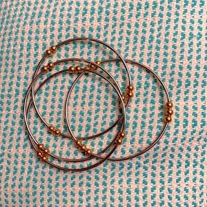 4 interlocking silver bracelets with gold balls